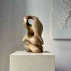 Side view of hand carved walnut sculpture with smooth flowing lines and natural wood grain