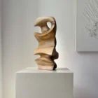 Abstract walnut wood sculpture detail showing smooth surface and natural grain patterns