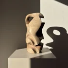 Hand carved walnut sculpture with dramatic light and shadow – minimalist interior art object