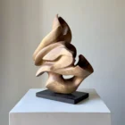 hand carved walnut wood sculpture organic form viewed from side angle