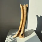 abstract-wood-vase-walnut-sculptural-form hand carved walnut wood vase sculptural form shown from the back in soft natural light