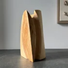 Hand carved ash wood vase showing natural contrast in grain and shape