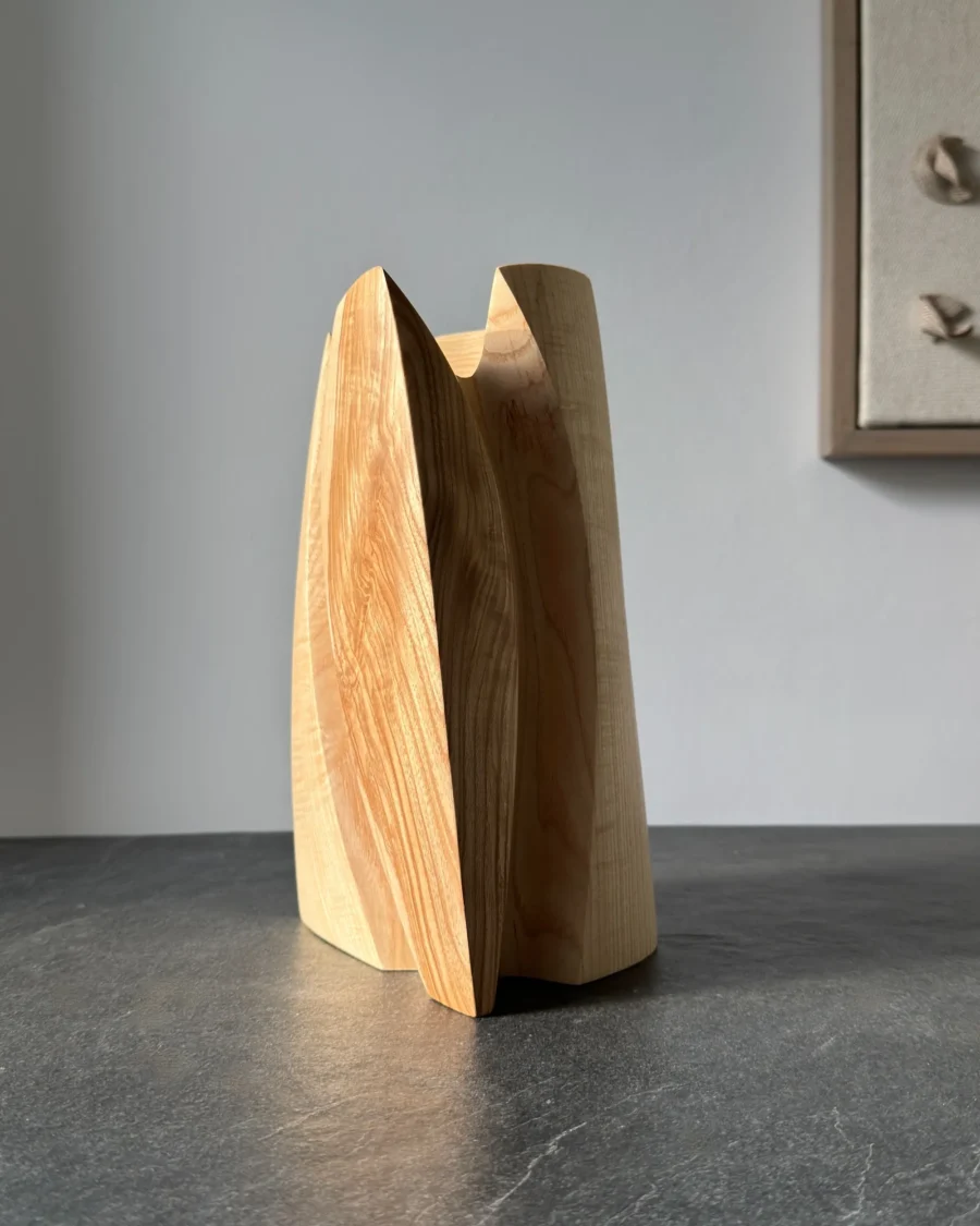 Hand carved ash wood vase showing natural contrast in grain and shape