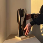 wooden sculpture scale shown in hands