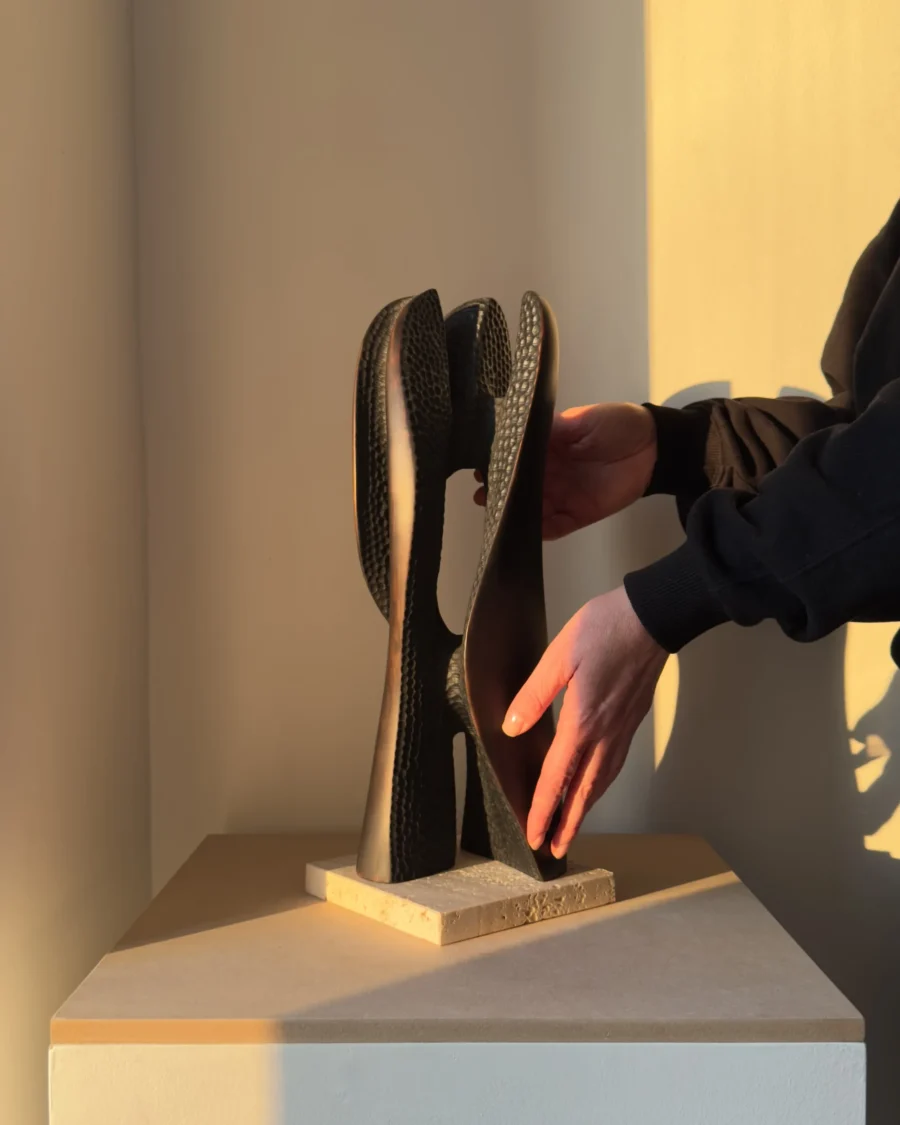 wooden sculpture scale shown in hands
