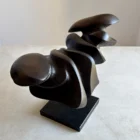 Angled view of Dark Expansion showing smooth organic curves transitioning into deeply carved textured surfaces