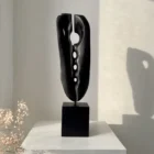 ember-guardian-black-wood-sculpture-interior-opening Charred wood sculpture showing organic form and carved openings