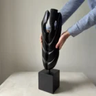 ember-guardian-wood-sculpture-scale-hands Scale view of sculpture held by hands showing size and proportions