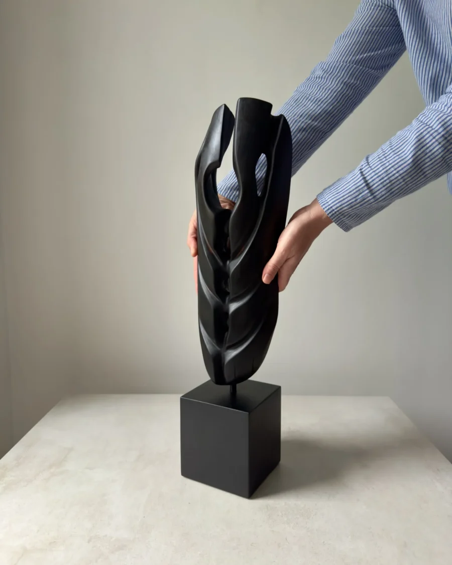 ember-guardian-wood-sculpture-scale-hands Scale view of sculpture held by hands showing size and proportions