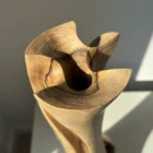 hand-carved-wood-vase-detail-opening detail of hand carved walnut wood vase with small circular opening and visible grain