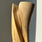 hand-carved-wood-vase-surface-texture close up of hand carved wooden vase surface showing smooth finish and subtle texture