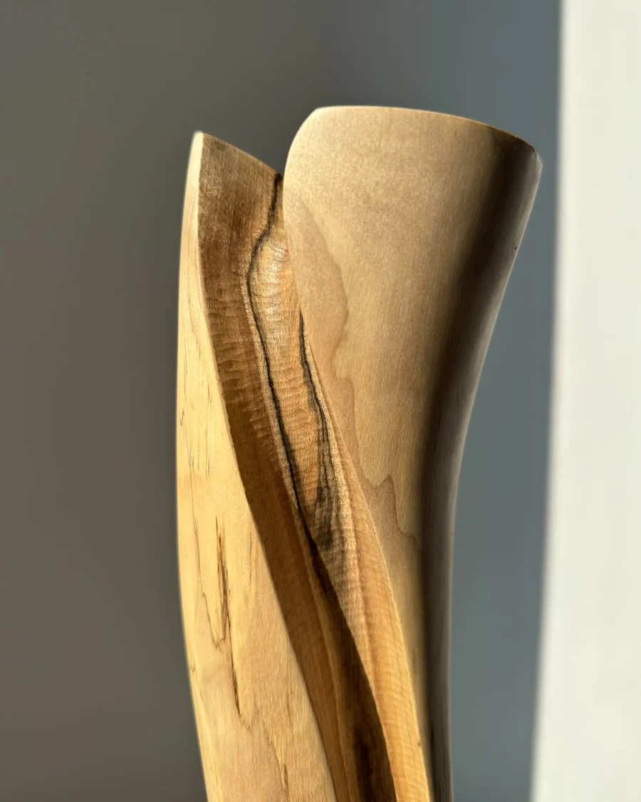 hand-carved-wood-vase-surface-texture close up of hand carved wooden vase surface showing smooth finish and subtle texture