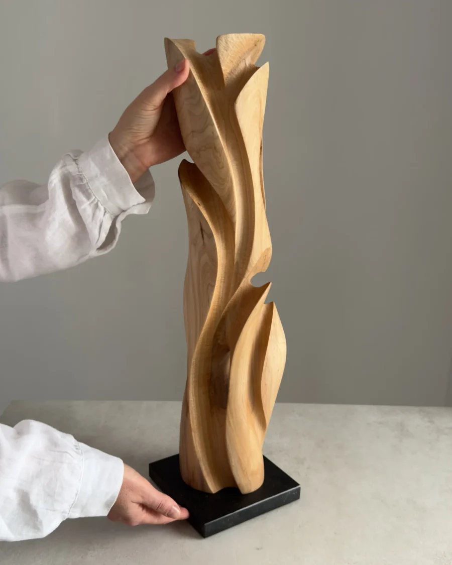 Wooden sculpture held in hands showing scale and proportions
