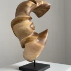 quiet-arc-walnut-wood-sculpture-side-view-ewebohome side view Hand carved walnut wood sculpture "Quiet Arc" on light background, abstract organic form with flowing curves and light shadow contrast