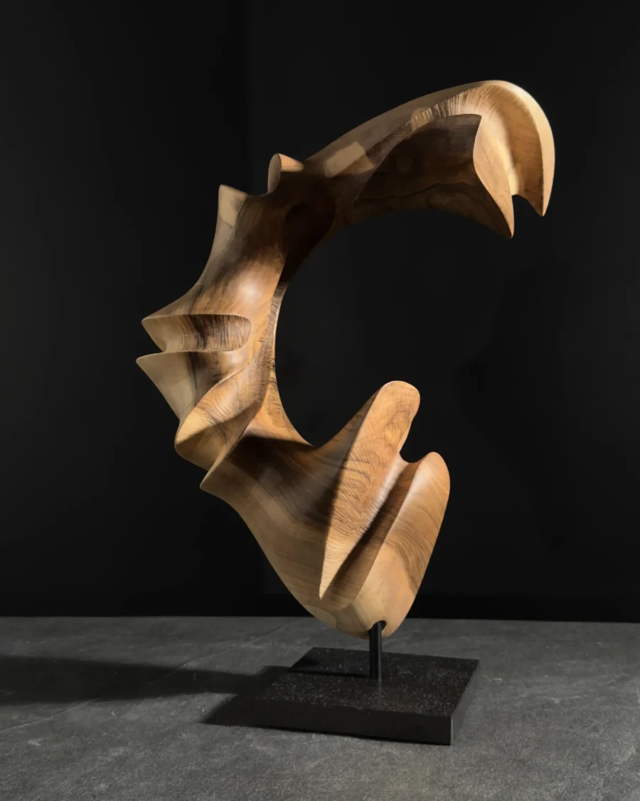 quiet-arc-wood-sculpture-back-view Abstract walnut wood sculpture side view, hand carved organic form with smooth flowing lines and sculptural depth