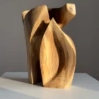 Abstract wooden sculpture Quiet Endurance illuminated by warm natural sunlight