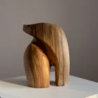 Back view of an abstract walnut sculpture showing smooth transitions and natural wood patterns.