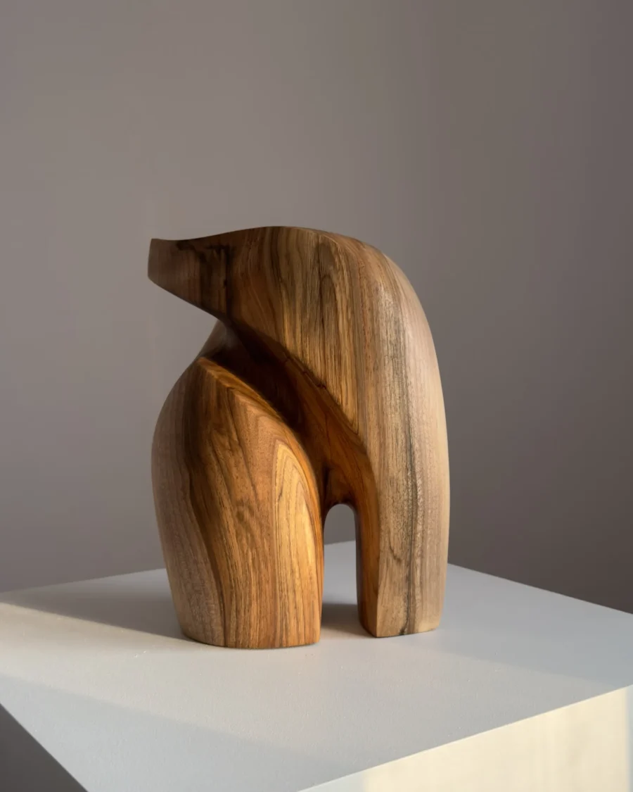 Back view of an abstract walnut sculpture showing smooth transitions and natural wood patterns.
