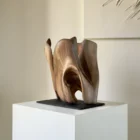 rebirth-abstract-wood-sculpture-walnut-ewebohome Hand-carved walnut wood sculpture “Rebirth” mounted on a natural slate base, showing an open hollow form.