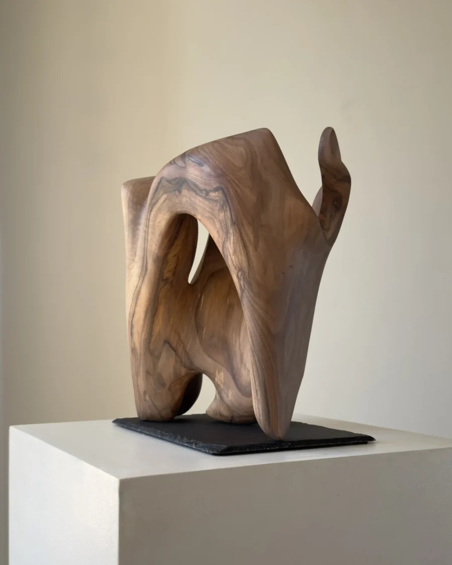 rebirth-wood-sculpture-full-view-ewebohome a wooden sculpture on white pedestal to show scale and carved structure.