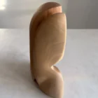 side profile of abstract wooden sculpture showing curved division