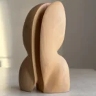 minimalist wood sculpture pear wood smooth carved form close view