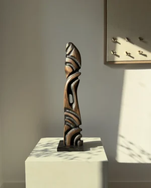 Sentinel hand carved black beech wood sculpture on a polished black granite base, front view.