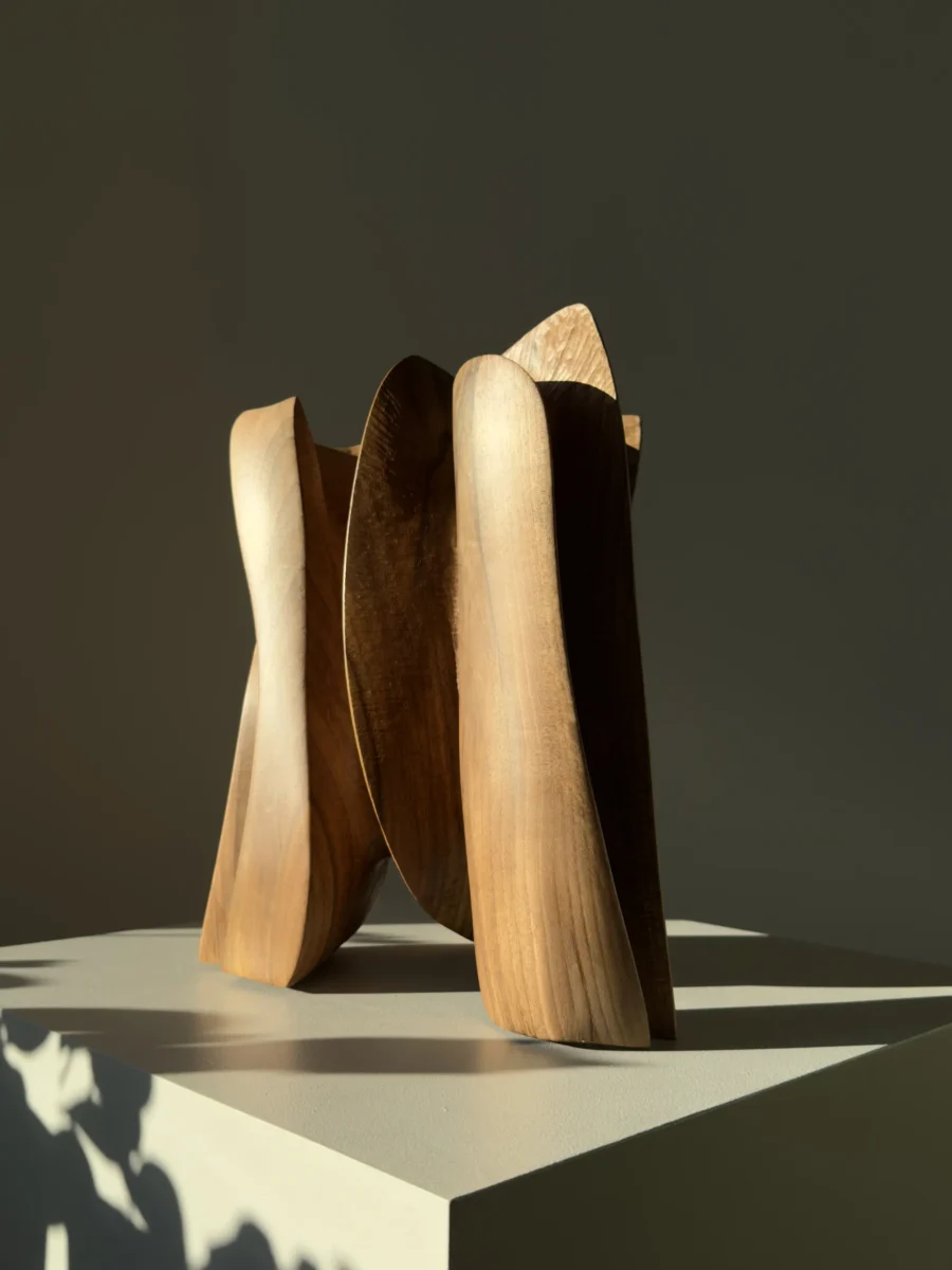 threefold-balance-contemporary-wood-sculpture-profile Rear angle of abstract walnut sculpture with sculptural openings and curved surfaces