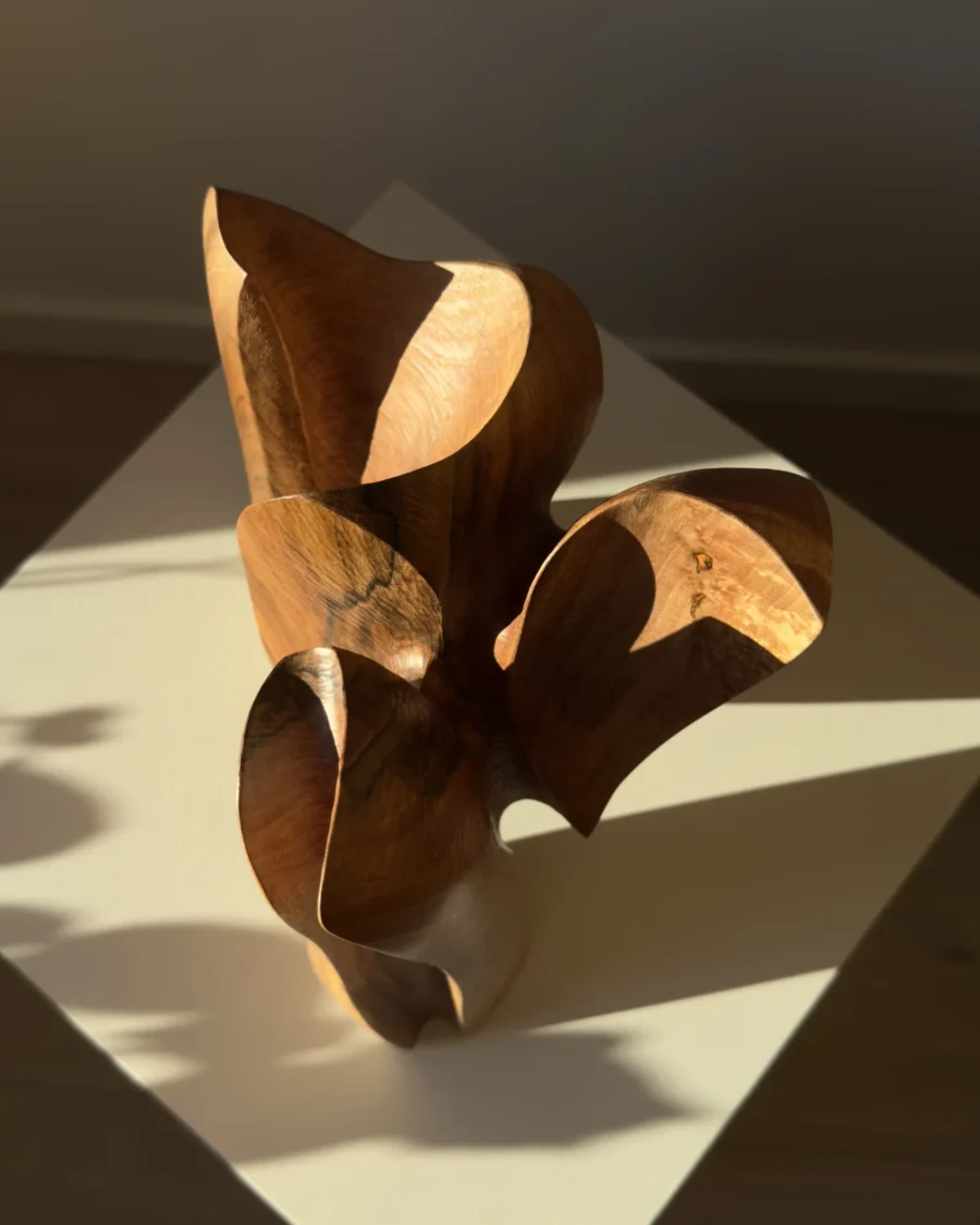 threefold-balance-top-view-walnut-sculpture Top view of hand carved walnut sculpture showing flowing openings and layered organic forms