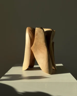 threefold-balance-walnut-wood-sculpture-front-light Contemporary walnut wood sculpture photographed from profile angle in dramatic sunlight