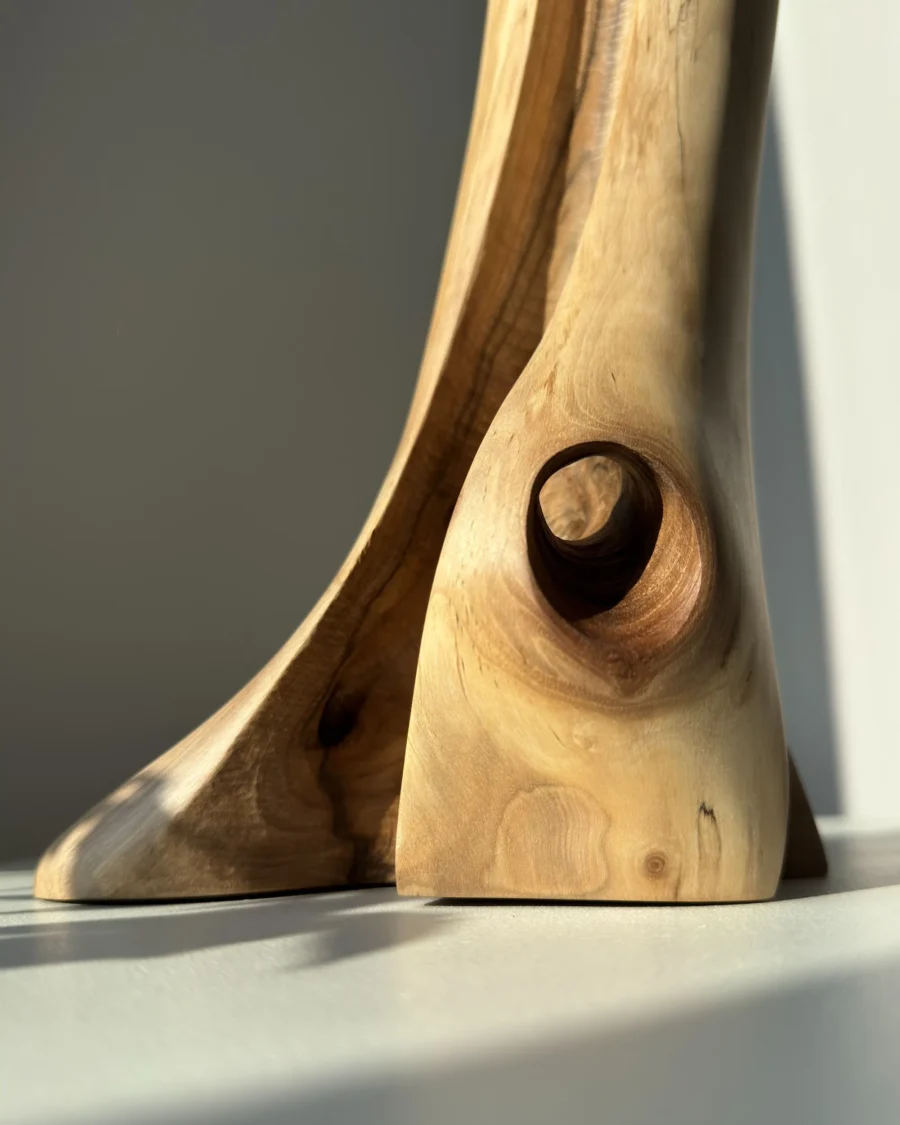 walnut-wood-vase-grain-detail-natural-light walnut wood vase base detail with natural grain patterns highlighted by sunlight