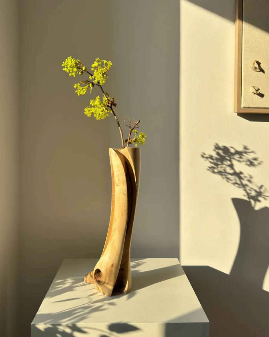 walnut-wood-vase-with-flowers-natural-light walnut wood vase with fresh branches in natural light showing sculptural form