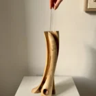 wood-vase-glass-tube-insert hand placing glass tube into hand carved walnut wood vase for fresh flowers