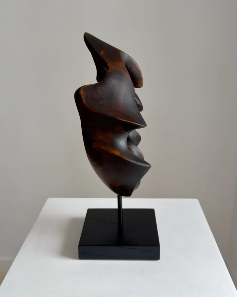 flame-memory-organic-wood-sculpture-profile-view Profile view of hand-carved walnut wood sculpture with blackened surface and flame-like organic form