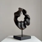 flame-memory-abstract-burnt-wood-sculpture-open-form Abstract fire-charred walnut sculpture with organic opening and smooth black surface, handmade by Ewelina Głowacz
