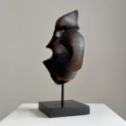 flame-memory-side-view-abstract-walnut-sculpture Side view of dark abstract walnut sculpture with flowing organic lines and sculptural opening