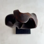 flame-memory-top-view-charred-walnut-sculpture Top view of hand-carved charred walnut sculpture showing fluid curves and sculptural opening