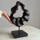 flame-memory-walnut-sculpture-scale-photo Hand beside abstract walnut sculpture “Flame Memory” showing scale and smooth fire-charred surface