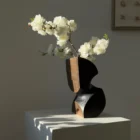 Organic modern wood vase illuminated by soft side sunlight