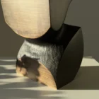 Hand carved apple wood vase showing natural grain and black textured surface