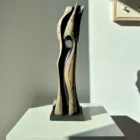 Back view of “Noctivis” hand-carved wood sculpture with flowing organic form and dark recessed interior surfaces.