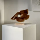 reveris-abstract-walnut-sculpture-side-view Side view of “Reveris” abstract walnut sculpture showing flowing organic planes and circular opening.
