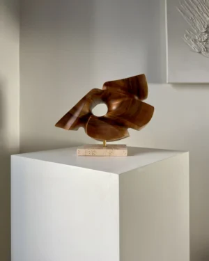 reveris-abstract-walnut-sculpture-side-view Side view of “Reveris” abstract walnut sculpture showing flowing organic planes and circular opening.