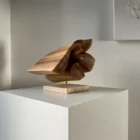reveris-abstract-wood-sculpture-light-shadow Abstract walnut wood sculpture “Reveris” photographed in minimalist interior with soft light and shadow.