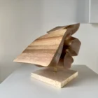 reveris-walnut-sculpture-travertine-base Handmade walnut sculpture “Reveris” mounted on natural travertine base with brass rod support.