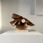 reveris-walnut-wood-sculpture-front-view Hand-carved walnut wood sculpture “Reveris” on travertine base photographed in soft natural light.