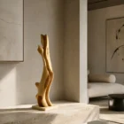 Rising Form hand carved applewood sculpture displayed in a contemporary minimalist interior with stone, natural light and warm neutral tones