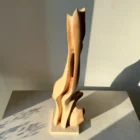 Applewood sculpture Rising Form interacting with natural light and shadow