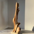 Side view of Rising Form abstract applewood sculpture with flowing organic curves