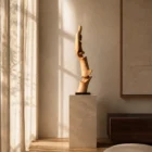 Apple wood sculpture “Soul of the Tree” displayed on a stone pedestal in a sunlit minimalist interior with linen curtains and natural shadows
